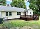 A charming home offers a beautiful stained wood deck and backyard for outdoor entertaining at 4421 Linwood Rd, Gastonia, NC 28052