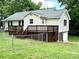 Charming home's spacious back yard is set up for relaxing outdoor entertaining with its large wooden deck at 4421 Linwood Rd, Gastonia, NC 28052