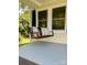 Close up of front porch swing with cushions and a throw blanket at 4421 Linwood Rd, Gastonia, NC 28052