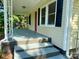 Spacious front porch featuring a porch swing and freshly painted floor at 4421 Linwood Rd, Gastonia, NC 28052