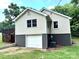 Attached garage for easy access with painted block foundation and neutral siding at 4421 Linwood Rd, Gastonia, NC 28052