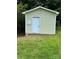 A home's yard features a darling shed with neutral siding and a classic white door at 4421 Linwood Rd, Gastonia, NC 28052