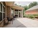 Back patio with brick accents, seating, and access to a screened-in porch at 4518 Courtyard Blvd # 4, Harrisburg, NC 28075
