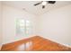 Charming bedroom with hardwood floors, a ceiling fan, and a window, providing a tranquil and inviting atmosphere at 4518 Courtyard Blvd # 4, Harrisburg, NC 28075