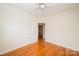 Relaxing bedroom with hardwood floors, a ceiling fan, and an open doorway, providing a comfortable and airy feel at 4518 Courtyard Blvd # 4, Harrisburg, NC 28075