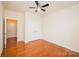 Comfortable bedroom with hardwood floors, a ceiling fan, closet doors, and an open doorway, maximizing space and convenience at 4518 Courtyard Blvd # 4, Harrisburg, NC 28075