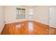 Bedroom featuring hardwood floors and natural light from multiple windows at 4518 Courtyard Blvd # 4, Harrisburg, NC 28075