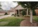 Beautiful home with manicured landscaping, brick facade, covered front porch, and mature shade trees at 4518 Courtyard Blvd # 4, Harrisburg, NC 28075