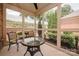 Inviting screened porch with a wicker table, chairs, and views of the landscaped backyard at 4518 Courtyard Blvd # 4, Harrisburg, NC 28075