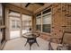 Screened-in porch with brick accents, ceiling fan, and exterior views at 4518 Courtyard Blvd # 4, Harrisburg, NC 28075