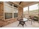 Screened-in porch with brick accents, ceiling fan, seating, and exterior views at 4518 Courtyard Blvd # 4, Harrisburg, NC 28075
