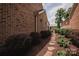 Beautifully landscaped yard with a stone path leading away from the brick home at 4518 Courtyard Blvd # 4, Harrisburg, NC 28075