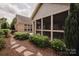 Beautifully landscaped yard with a stone path leading to the screened porch and back patio at 4518 Courtyard Blvd # 4, Harrisburg, NC 28075