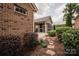 Landscaped yard with a stone path connecting the back patio to the home's screened-in porch at 4518 Courtyard Blvd # 4, Harrisburg, NC 28075