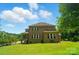 Spacious backyard features a well-manicured lawn and mature trees at 463 Langston Place Dr, Fort Mill, SC 29708