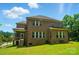 Well-maintained backyard showcases the home's full brick exterior and a covered porch at 463 Langston Place Dr, Fort Mill, SC 29708