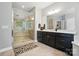 Bathroom showcasing a large walk-in shower with a glass enclosure and dark wood vanity at 463 Langston Place Dr, Fort Mill, SC 29708