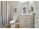 Compact bathroom featuring a toilet, vanity with storage, and a shower with a curtain at 463 Langston Place Dr, Fort Mill, SC 29708
