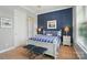 Cozy bedroom with stylish blue accent wall, queen bed, bedside tables and carpeted flooring at 463 Langston Place Dr, Fort Mill, SC 29708