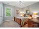Bedroom featuring warm lighting, a wooden bed frame, and neutral decor at 463 Langston Place Dr, Fort Mill, SC 29708