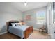 Cozy bedroom with a comfortable bed, neutral walls, and a sunlit window at 463 Langston Place Dr, Fort Mill, SC 29708