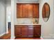 Butler's pantry with granite countertops and custom cabinetry, conveniently located between kitchen and dining room at 463 Langston Place Dr, Fort Mill, SC 29708