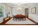 Formal dining room with tray ceiling, chandelier, and wainscoting is perfect for entertaining and Gathering dinners at 463 Langston Place Dr, Fort Mill, SC 29708