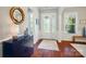 Elegant foyer with hardwood floors, decorative mirror, and a stylish console table with lamp at 463 Langston Place Dr, Fort Mill, SC 29708