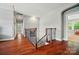 Upstairs hallway with hardwood floors, iron railing, and architectural details at 463 Langston Place Dr, Fort Mill, SC 29708