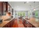 Gourmet kitchen showcasing stainless steel appliances, granite countertops, and sleek dark wood cabinetry at 463 Langston Place Dr, Fort Mill, SC 29708