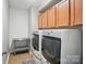 Convenient laundry room features a washer, dryer, storage cabinets and ample counter space at 463 Langston Place Dr, Fort Mill, SC 29708