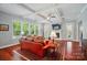 Spacious living room featuring coffered ceilings, a fireplace, large windows, and hardwood floors at 463 Langston Place Dr, Fort Mill, SC 29708
