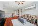 Spacious living room with hardwood floors, a plaid sofa, and access to the upstairs hallway at 463 Langston Place Dr, Fort Mill, SC 29708