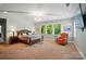 Spacious main bedroom with a plush bed, sitting area, and abundant natural light at 463 Langston Place Dr, Fort Mill, SC 29708