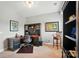A well-lit home office with a dark wood desk, chair, and ample shelving for storage at 463 Langston Place Dr, Fort Mill, SC 29708