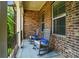 Inviting front porch with stone accents, rocking chairs, and a cozy outdoor rug at 463 Langston Place Dr, Fort Mill, SC 29708