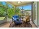 Relaxing screened porch with comfortable seating, ceiling fan and views of the backyard and trees at 463 Langston Place Dr, Fort Mill, SC 29708