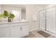 Bathroom with a glass shower, double sink vanity with white cabinets and luxury vinyl flooring at 4689 Fanning Rd, Hickory, NC 28602