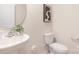 Elegant half bathroom featuring modern fixtures, a round mirror, and a minimalist design at 4689 Fanning Rd, Hickory, NC 28602