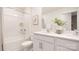 Well-lit bathroom featuring double sinks, white cabinetry, and a combined shower and tub at 4689 Fanning Rd, Hickory, NC 28602