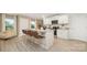 Open kitchen with island seating, stainless appliances, and light wood floors in neutral tones at 4689 Fanning Rd, Hickory, NC 28602