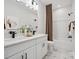 Beautiful bathroom featuring double sinks, white cabinets, modern fixtures, tub, and stylish decorative touches at 502 Webster Ln, Cramerton, NC 28032