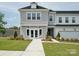 Charming two-story townhome featuring a gray exterior, manicured landscaping, and an attached garage at 502 Webster Ln, Cramerton, NC 28032