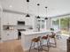 Bright kitchen featuring a center island, stainless appliances, and an adjacent dining area at 502 Webster Ln, Cramerton, NC 28032