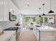 Bright modern kitchen with white cabinets, stainless appliances, and breakfast nook with backyard views at 502 Webster Ln, Cramerton, NC 28032