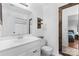 Bathroom featuring a large vanity, decorative mirror, and linen closet at 510 Sw Viking Sw Pl, Concord, NC 28025