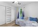 Bright bedroom with natural light, white walls, built-in shelves, and a blue daybed at 510 Sw Viking Sw Pl, Concord, NC 28025