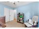 Cozy bedroom featuring light blue walls, neutral carpet, and comfortable chair with ottoman at 510 Sw Viking Sw Pl, Concord, NC 28025
