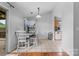 Light-filled dining area with tile flooring, table with seating for four and access to patio at 510 Sw Viking Sw Pl, Concord, NC 28025