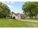 Charming home exterior with lush green lawn, mature trees, and a paved driveway at 510 Sw Viking Sw Pl, Concord, NC 28025